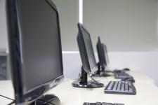 Desktop computers on work tables.