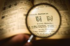 Magnifying glass focused on page in a book