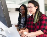 Two ladies looking at computer screen