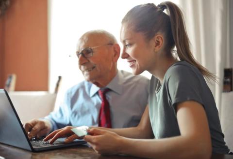 Woman and man looking at laptop screens