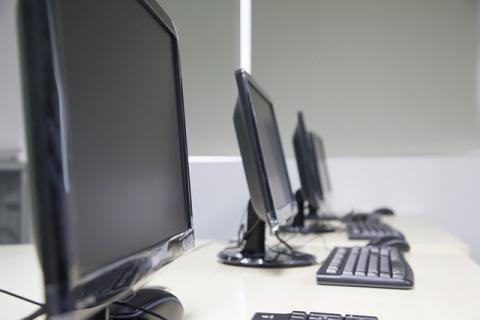 Desktop computers on work tables.