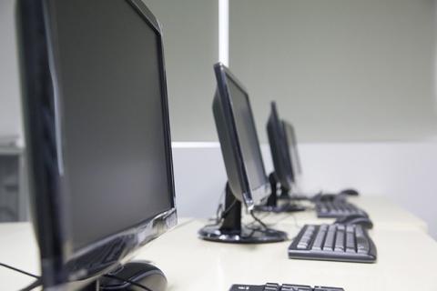 Desktop computers on work tables. 