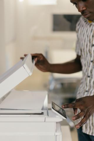 Man using scanning function on copier machine