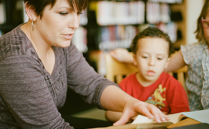 Woman reading to a group of children